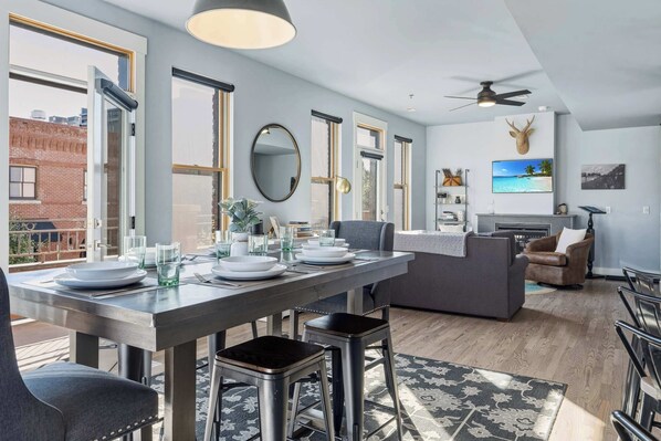 A modern kitchen with a dining area, large windows, and a ceiling fan. - 5 Star Listing! 1 Min Walk to Arkansas River (Salida)