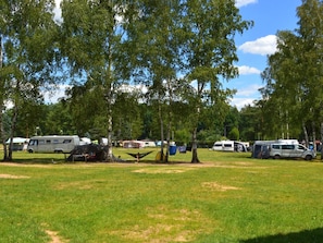 A campground with RVs parked on grassy areas, surrounded by trees. - Kemp Stříbrný rybník by Interhome (Hradec Kralove)