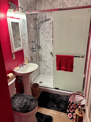 A bathroom with a shower, sink, mirror, and red walls. - That 70’s House: boogie woogie bungalow. (Salina)
