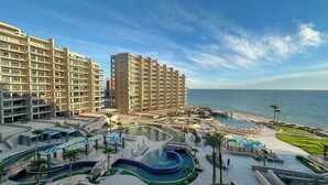 A resort with high-rise buildings, a swimming pool, and a beach view. - The Iconic Beachfront 3BR Condo (Puerto Peñasco)