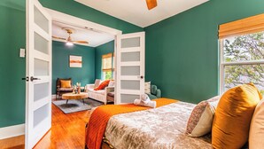 A bedroom with a bed, a chair, a desk, and a window. - Historic Oak Cliff Retreat - Yoga & Wellness Room Near Bishop Arts (Dallas)