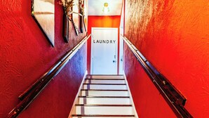 A staircase with a sign reading 'LAUNDRY' at the top, leading to a room with a white door. - Historic Oak Cliff Retreat - Yoga & Wellness Room Near Bishop Arts (Dallas)