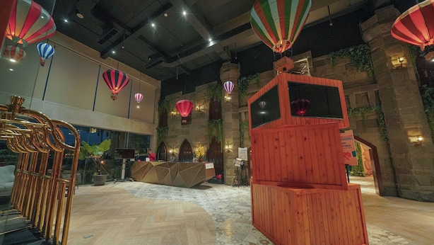 Ein modernes Interieur mit einer Rezeption, Heißluftballons und einer außergewöhnlichen Holzkonstruktion.