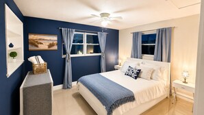 A bedroom with a bed, a nightstand, a wall-mounted shelf, a ceiling fan, and a window with curtains. - 3 bedroom, 2 full baths, with private pool, barbecue and  pet designated a (Oakland Park)