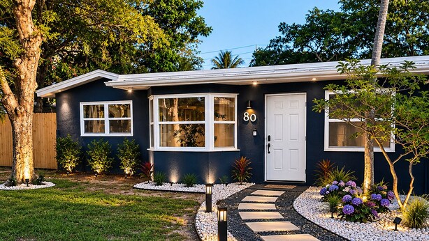 A house with a number 80 sign, a front yard with a pathway, and a small garden with plants. - 3 bedroom, 2 full baths, with private pool, barbecue and  pet designated a (Oakland Park)