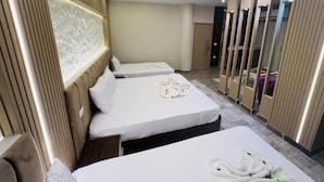 A hotel room with two beds, a large mirror, and a wall-mounted light fixture. - pyramids Moon IIn (Giza)