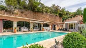 A swimming pool with a tiled border, outdoor seating, and a view of a hillside. - “Lavender Room” Guest Room with Shared Pool, Garden, and Wi-Fi (Bédoin)
