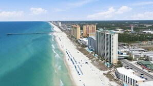 A coastal cityscape with a beach, high-rise buildings, and a pier. - 3 Bedroom in Aqua Resort! 811 Renovated with Gorgeous Views!  New listing (Panama City Beach)