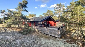 Eine Hütte mit überdachter Veranda, umgeben von Bäumen.