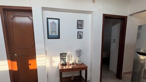 A kitchen with a coffee maker, blender, and framed pictures on the wall. - APARTMENT IN LA SALLE 3 TUXTLA GUTIERREZ (NEAR TORRE CHIAPAS, POLIFORUM) (Tuxtla Gutiérrez)
