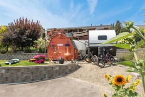 A residential area with a red building labeled 'COOP - A - CINO,' a white RV parked in front, and a bicycle.