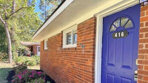 A brick building with a blue door, a small window, and a mailbox. - Spacious & Cozy 3BR | Perfect for Families (Augusta)