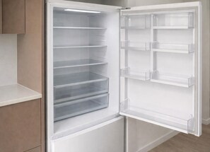 A modern, empty refrigerator with transparent shelves and a white exterior. - Warm & Convenient Home Near the Lake in Pemulwuy (Pemulwuy)
