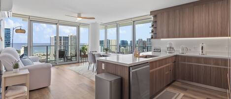 Bright corner condo with modern kitchen, balcony, and stunning city views