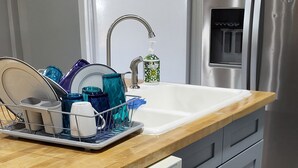 Cuina moderna amb rentaplats, rentavaixelles, vàter i electrodomèstics d'acer inoxidable.