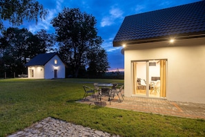 A house with a patio, a dining area, and a garage. - Brick Cottage Near Baltic Sea and Windmill (gmina Karnice)