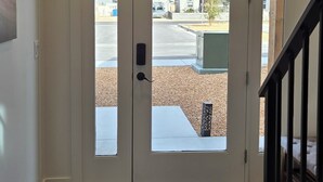 A double door entrance with a doormat, a wooden floor, and a staircase to the right. - Antelope Canyon Comfy Townhouse - Sleeps 11 (Page)