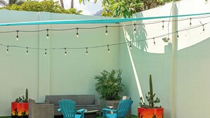 A patio with outdoor furniture, string lights, and potted plants. - IslaRita Stays - spacious studio near Eagle Beach (Oranjestad)