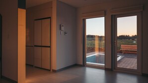 A modern interior with a sliding glass door leading to an outdoor deck.