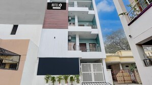 A multi-story hotel with a sign reading 'HOTEL O Company-Serviced.' - Premium Neelam Hotel (Bareilly)