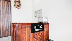 A hotel reception desk with a sign reading 'HOTEL O' and a 'Company-Serviced' label. - Deluxe Hotel Lara Heritage (Amer)