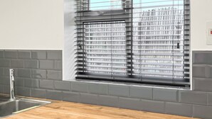 A kitchen with a wooden countertop, grey cabinets, and a window with blinds. - Lamp Post Cottage 3 - UK50955 (Bridlington)