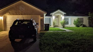 A residential house with a garage, a driveway, and a lawn. - Stay In peace and rlx (Brevard County)