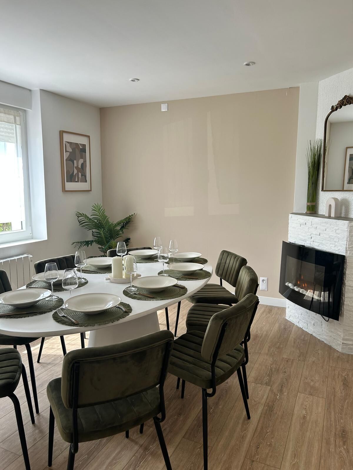 A dining area with a round table set for six, surrounded by six chairs.