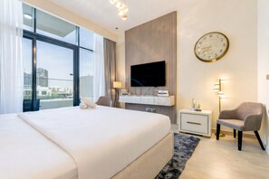Une chambre d’hôtel moderne dotée d’un grand lit, d’une télévision, d’une horloge et offrant une vue sur la ville.