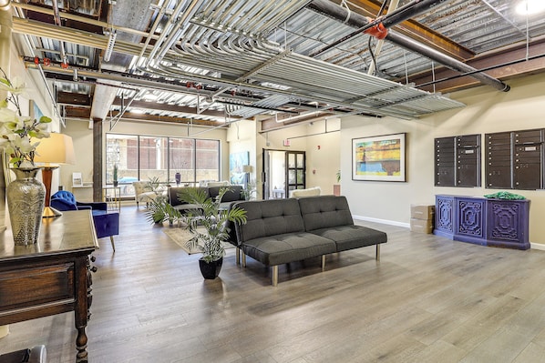 A spacious living area with a sofa, a coffee table, and a potted plant.