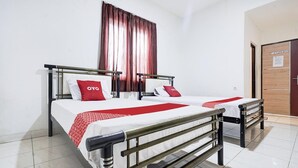 A double bed with a metal frame, white bedding, and red accents. - Luxury Twin Stay with Free WiFi and Parking (Makassar)