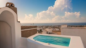 A rooftop pool with a view of the sea and a town in the distance. - Dionysos Wine Stay, Mountain Views (Emporeio)