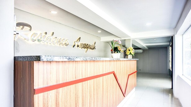 A reception desk with a wooden finish and a red accent line.