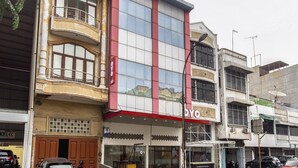 A multi-story building with a prominent 'OY' sign, large windows, and a balcony on the second floor. - Family Luxury Suite W/Free WiFi and Parking (Medan)