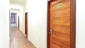 A hallway with wooden doors, one marked with the number 208. - Family Luxury Suite W/Free WiFi and Parking (Medan)