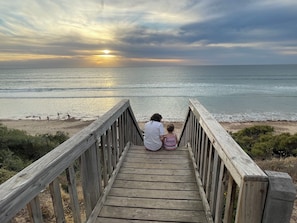 A wooden boardwalk leading to a beach with a sunset in the background. - Beach and Winery getaway. The perfect base for a family holiday. Pet friendly (Seaford)