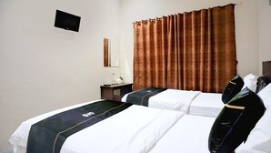 A hotel room with two beds, a flat-screen TV, a small table, and a large window with curtains. - Luxury Twin Comfort Stay W/ Free Parking and Pool (Medan)