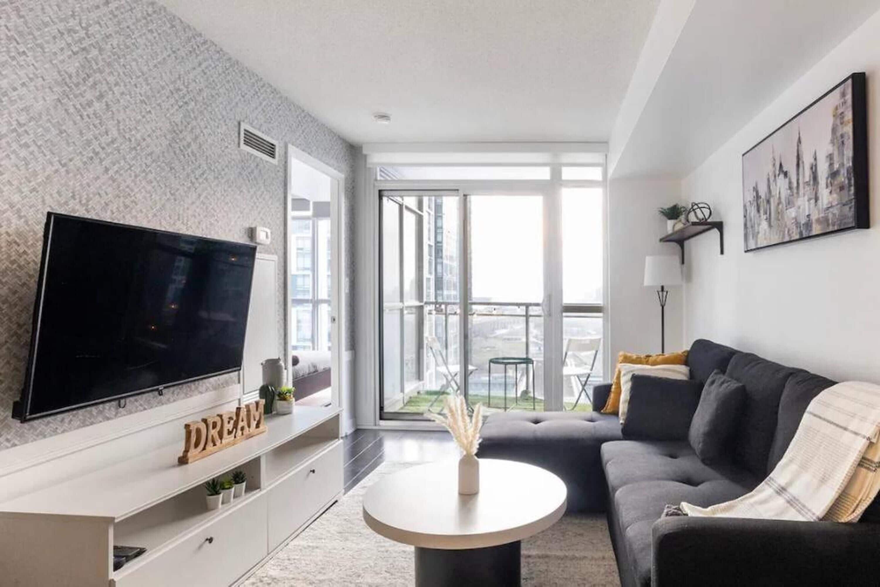 Deluxe Suite, City View | Living area | 55-inch TV with digital channels