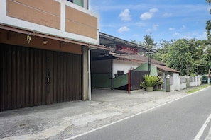 A building with a closed garage door, a gated entrance, and a sign above the door.