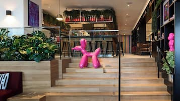 A staircase with wooden steps and a pink sculpture in the center.