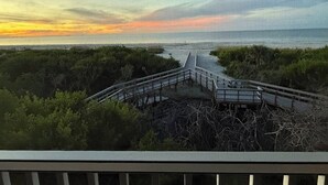 A coastal bridge with a view of the ocean and a sunset. - Beachfront 2BR Condo at Casa Ybel Resort: Top Floor, Private Balcony Ocean Views (Sanibel)