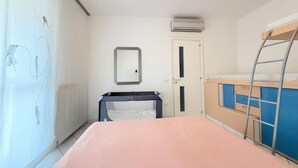 A bedroom with a bed, a wardrobe, a mirror, an air conditioning unit, and a ladder. - P086 - Porto Recanati, villa with garden and terrace (Porto Recanati)