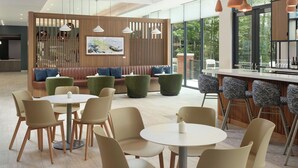 A modern interior with a bar area, seating, and tables. - Element by Marriott Bainbridge Riverfront (Bainbridge)