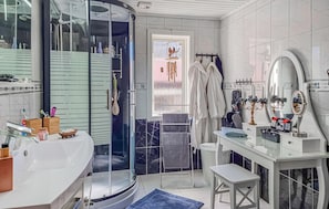 A modern bathroom with a glass shower enclosure, a white vanity with a mirror, and a white sink. - Cozy home in Spekeröd with sauna (Spekeröd)
