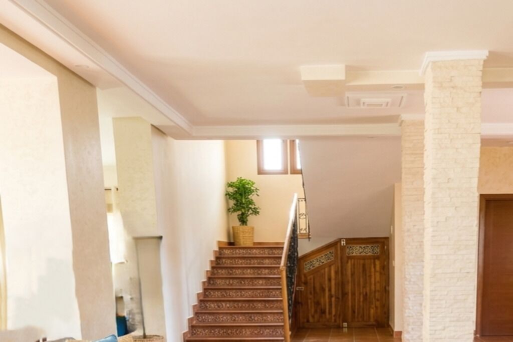 A staircase with patterned steps leading to a wooden door.