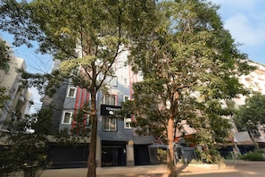 A multi-story building with a sign reading 'TOWNHOUSE.' - Super Townhouse SR Nagar Metro Hyderabad (Hyderabad)