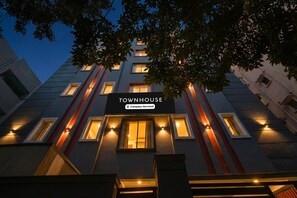 A multi-story building with illuminated windows and a sign reading 'TOWNHOUSE.' - Super Townhouse SR Nagar Metro Hyderabad (Hyderabad)