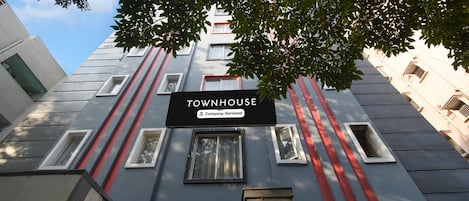 A building with a sign reading 'TOWNHOUSE' and a company-serviced label.
