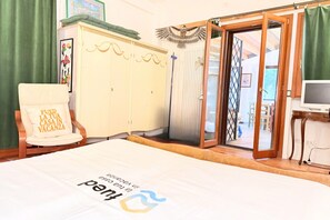 A room with a bed, a chair, a wardrobe, a door leading outside, and a television. - S359 - Sirolo, dependance with garden  (Sirolo)