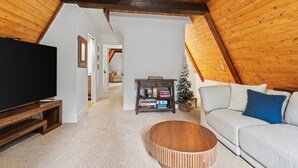 Smart TV, fireplace - Spread out across three levels, this cozy A-frame offers space for everyone to unwind—from the open main living area to the upstairs lounge and playful loft. A great fit for families or small groups looking for comfort and a little fun. (Shaver Lake)